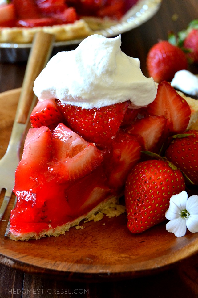 STRAWBERRY PIE ON A BROWN PLATE WITH WHIPPED CREAM