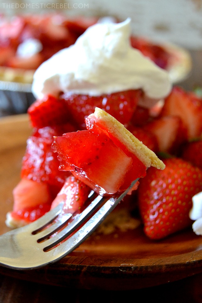 CLOSE UP PICTURE OF A BITE OF STRAWBERRY PIE ON A FORK