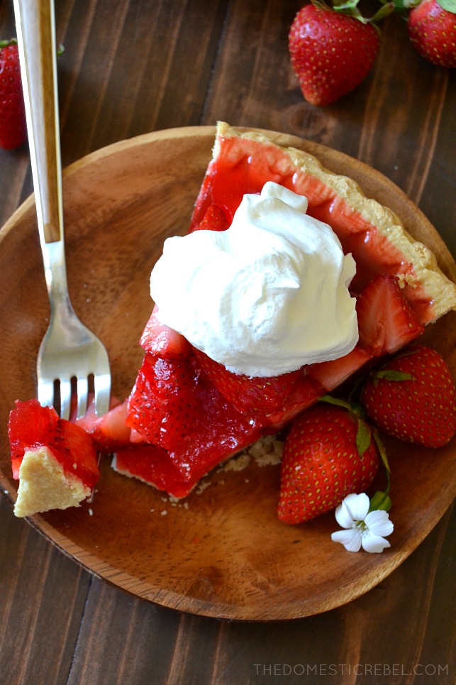 AERIAL VIEW OF ONE SLICE OF STRAWBERRY PIE WITH A BITE ON A FORK
