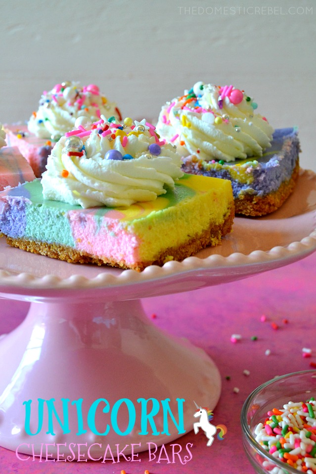 Unicorn Rainbow Cheesecake Bars on pink cake stand with sprinkles