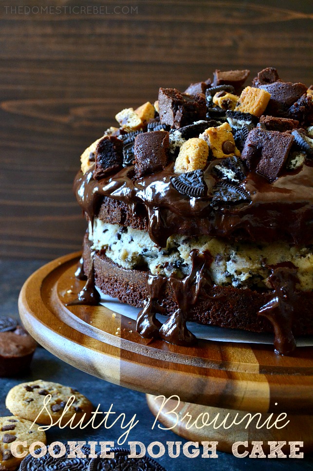 WHOLE SLUTTY BROWNIE COOKIE DOUGH CAKE ON A WOOD CAKE STAND