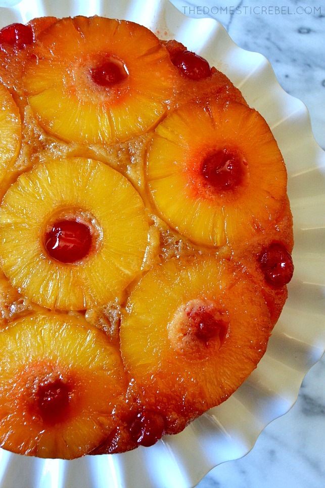 AERIAL VIEW OF A PINEAPPLE UPSIDE DOWN CAKE ON A WHITE CAKE STAND