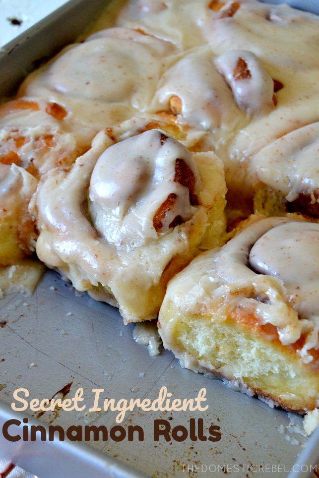 cinnamon rolls arranged in a pan with 3 rolls missing
