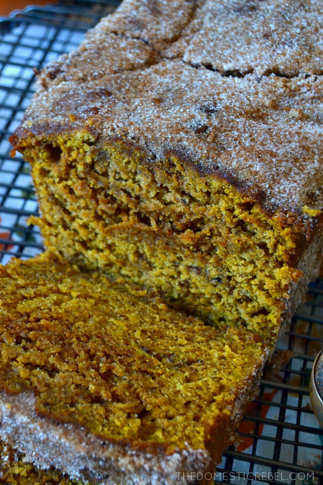 loaf of pumpkin churro bread with two pieces sliced 