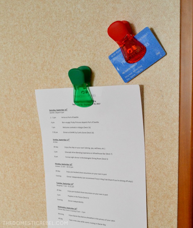 red and green magnetic chip clips holding an itinerary and a card