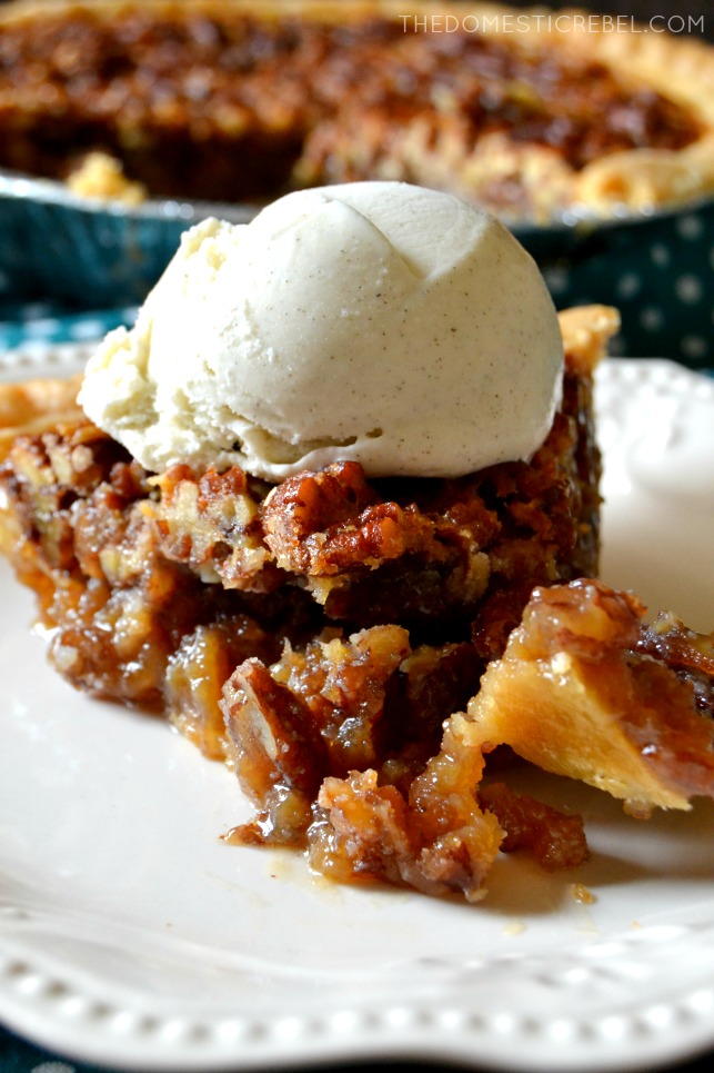 slice of bourbon pecan pie ala mode with a bite missing 