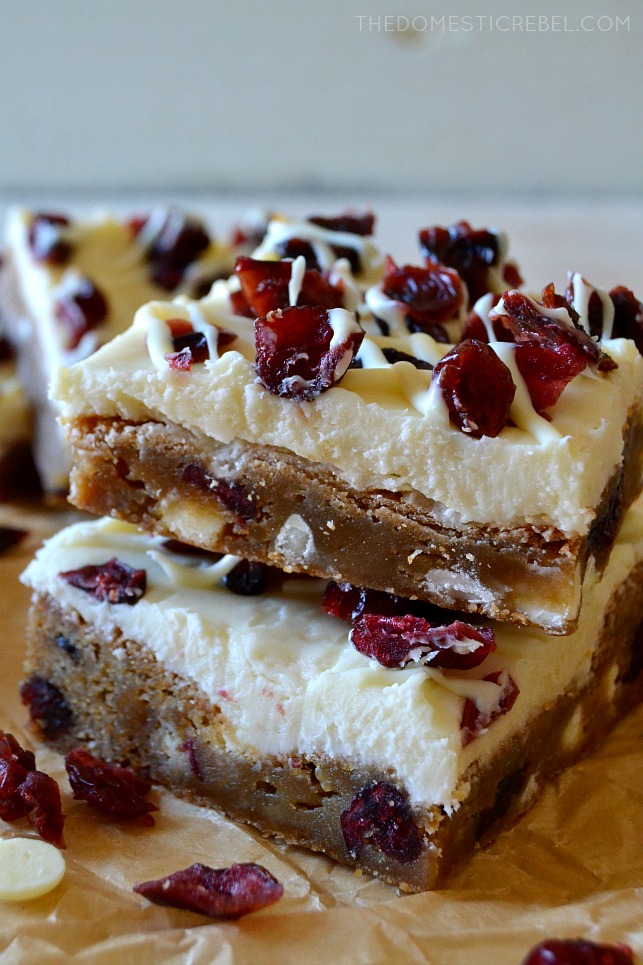 two cranberry bliss bars stacked on parchment paper