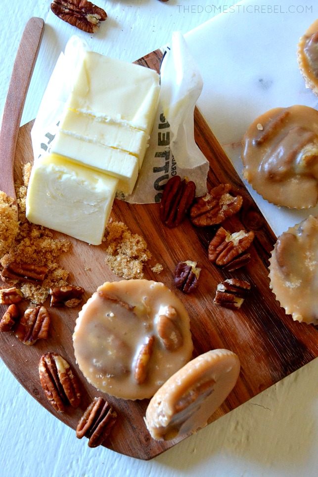 aerial view of pecan pralines on a cutting board with a stick of butter