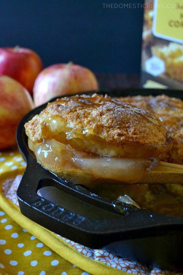 apple cinnamon cornbread cobbler being scooped out of a skillet 