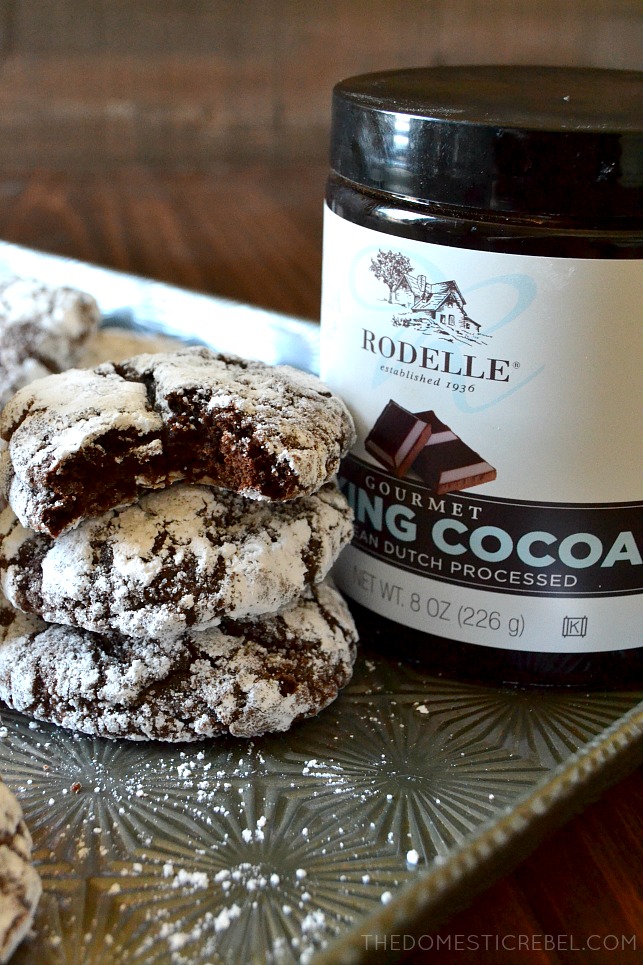 a stack of chocolate crinkle cookies in front of a jar of Rodelle baking cocoa