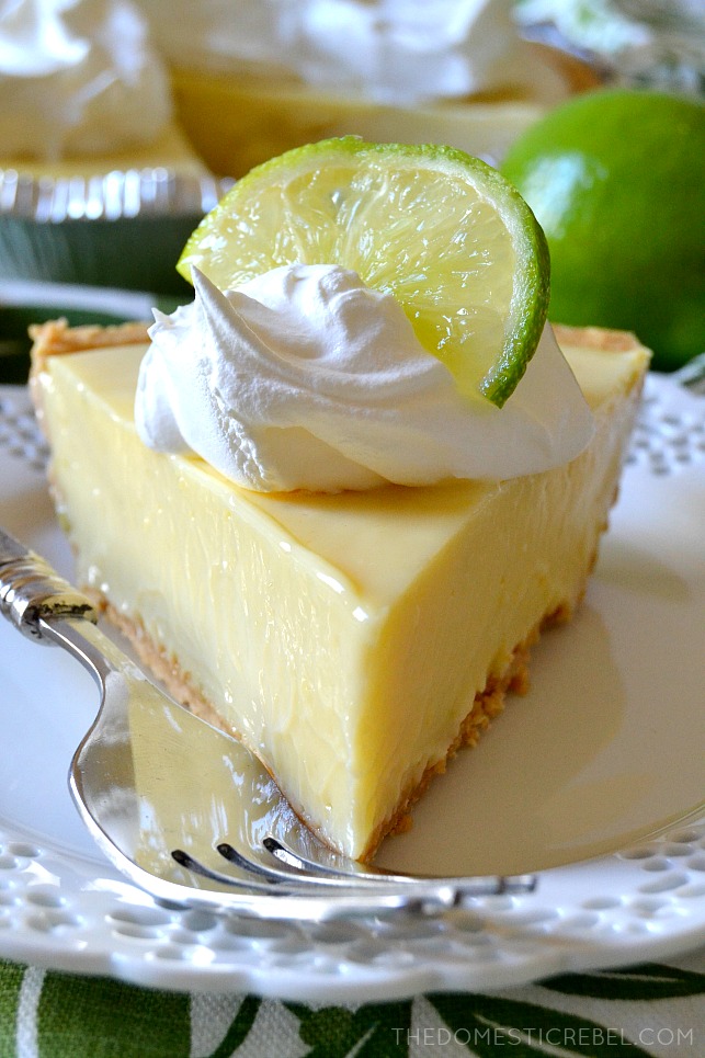 slice of key lime pie topped with whipped cream and a lime wedge 