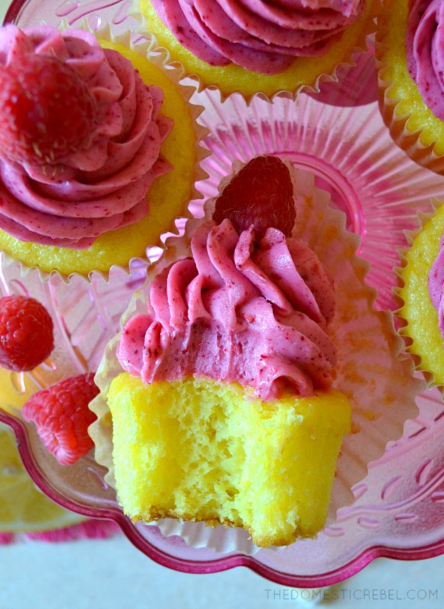 aerial view of a raspberry lemonade cupcake on its side with a bite missing