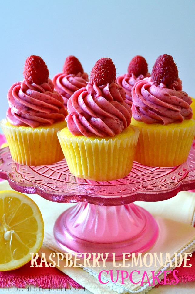 five raspberry lemonade cupcakes arranged on a pink glass cake stand