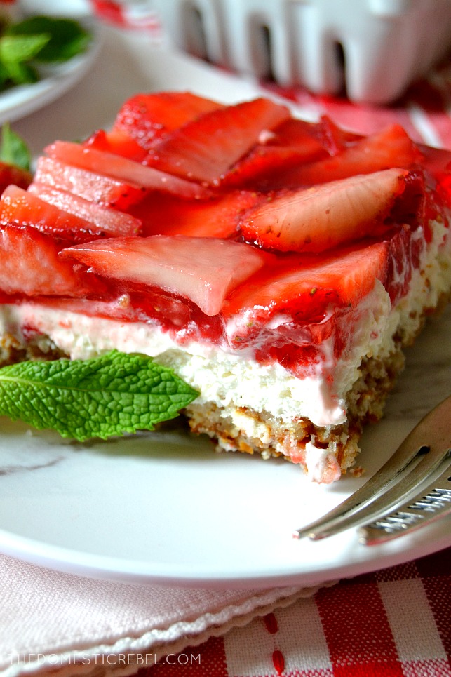 one strawberry pretzel salad bar on a white plate with mint leaves 