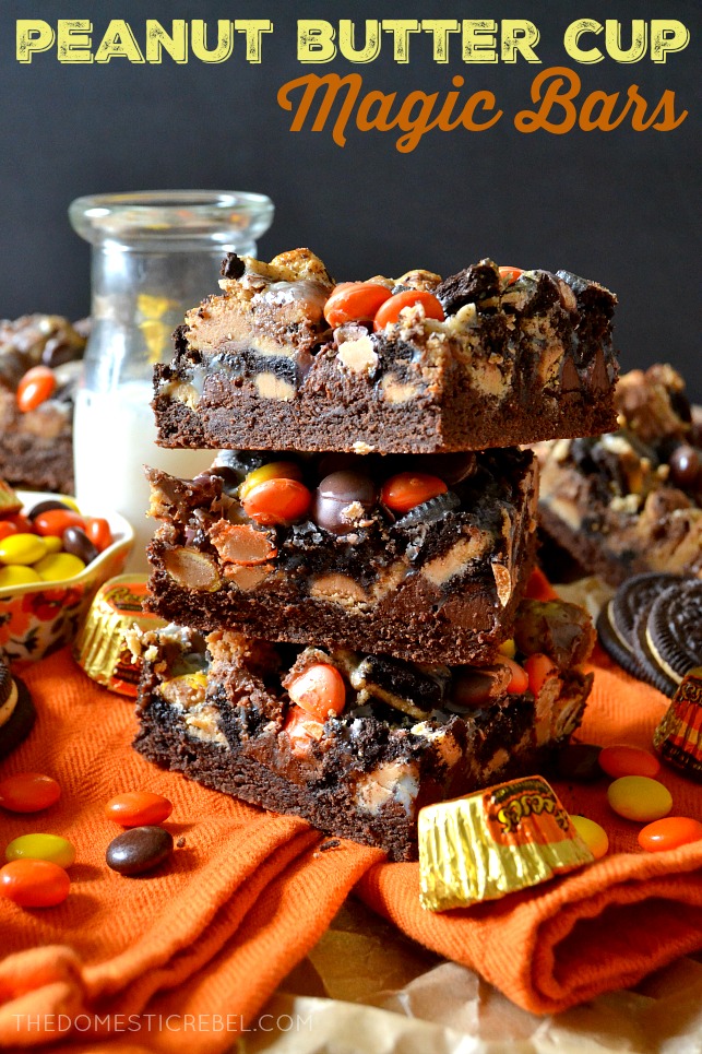 three peanut butter cup magic bars stacked on an orange towel 