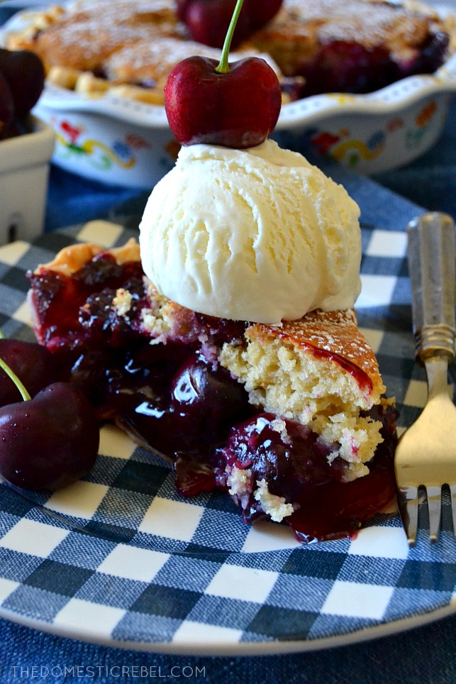 slice of cherry cobbler pie topped with ice cream and a cherry 