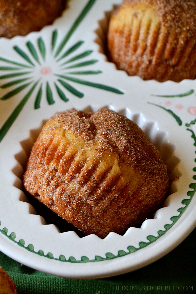 a churro donut muffin on its side in ceramic muffin pan 