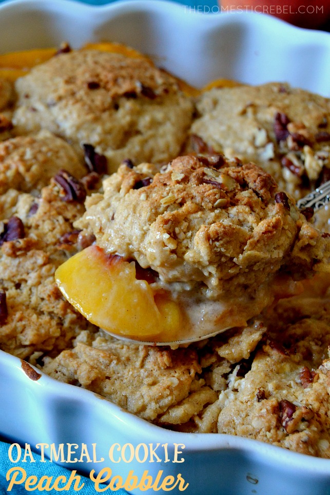 A spoonful of oatmeal cookie peach cobbler above the whole pan of cobbler