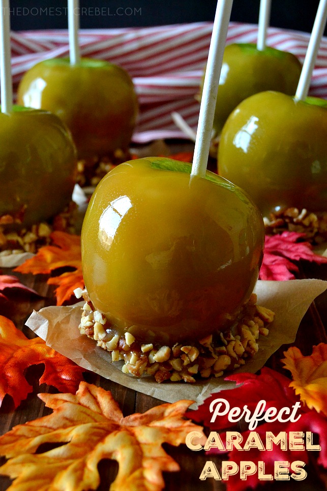 Close up of one caramel apple in front of four other caramel apples