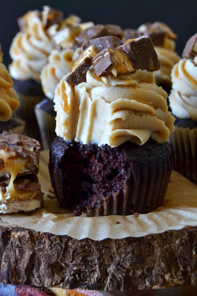 These Super Easy Snickers Cupcakes are heavenly, delicious and simple! They start with a moist and fudgy chocolate cupcake that's topped with a silky, creamy peanut butter frosting and is topped with chopped chewy Snickers pieces and lots of salted caramel sauce! Perfect for using up leftover candy! 