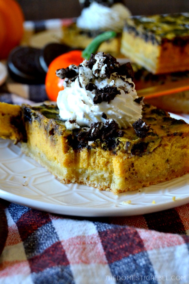 These Oreo Pumpkin Cheesecake Bars are heavenly! Silky smooth, perfectly spiced, creamy pumpkin cheesecake filled with crunchy, chocolate Oreo cookie pieces on a buttery shortbread crust. Whipped cream is mandatory for these crowd-pleasing, super simple bars!