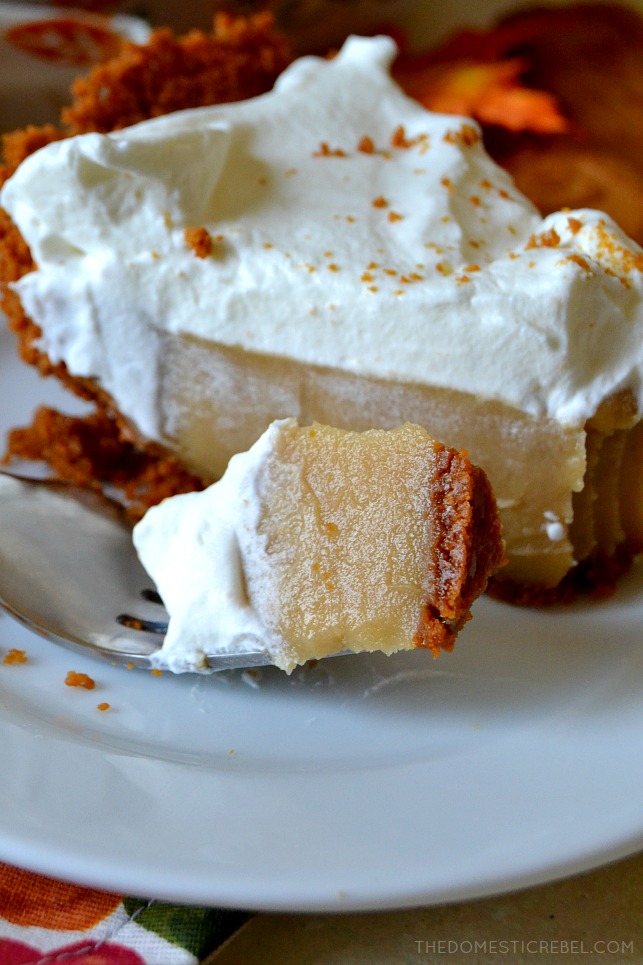 A bite of butterscotch pudding pie on a fork that is sitting on a white plate