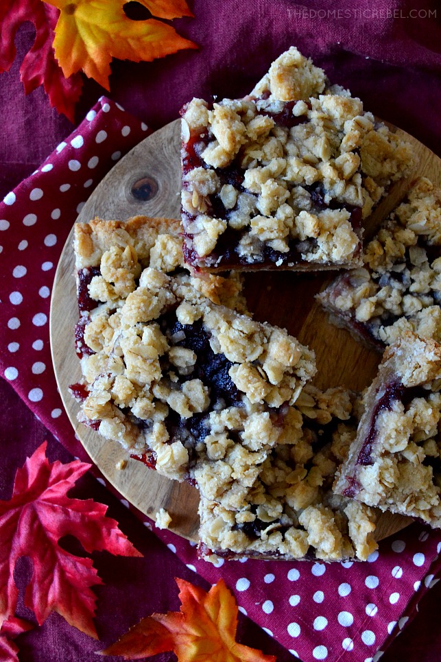 Aerial view of cranberry crumble bars piled on a piece of wood
