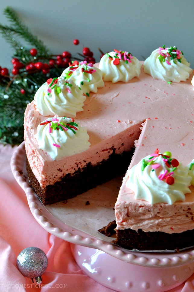 Whole peppermint brownie cheesecake missing one slice 