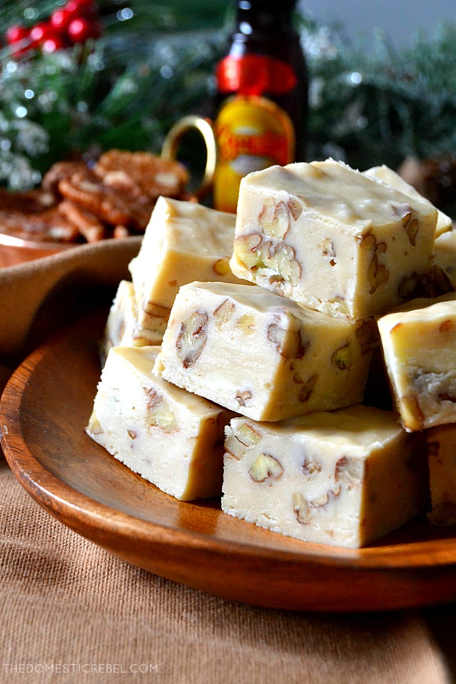 Close-up of a pile of Kahlua fudge pieces on a wooden plate in front of a holiday backdrop