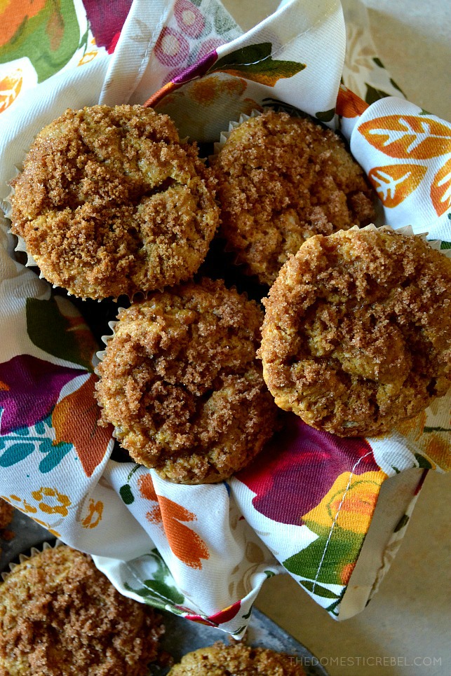 Four gingerbread crumb muffins in a towel lined bowl 
