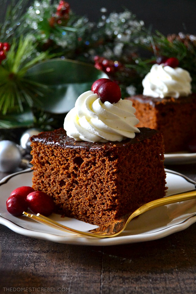 A square of gingerbread cake with whipped cream and a berry on top