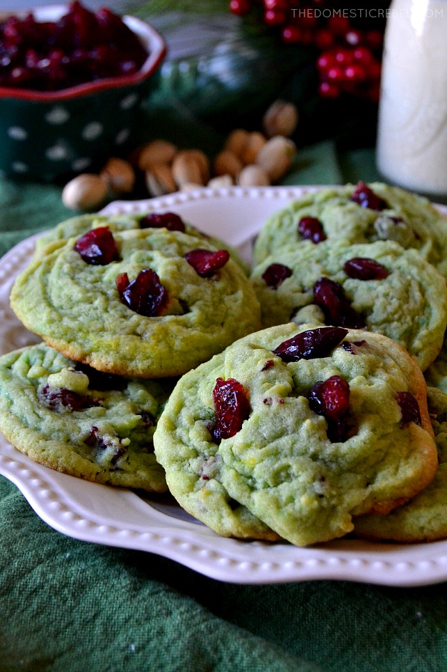 A close-up of cranberry pistachio pudding cookies on a white plate