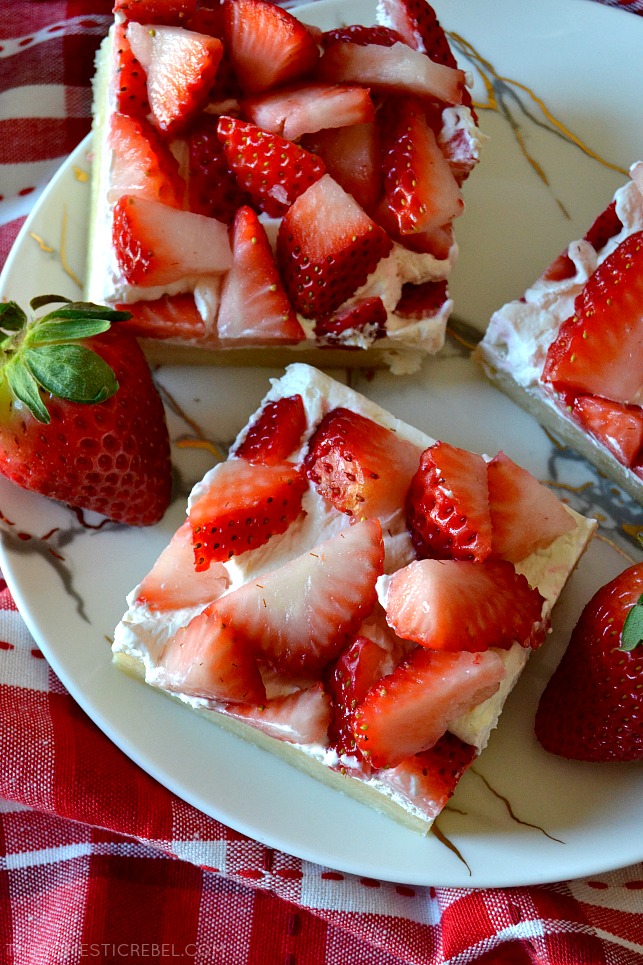 These Strawberry Shortcake Bars are soft, chewy and cakey cookie bars loaded with a light cream cheese whipped frosting and tons of fresh strawberries! Use any kind of fruit you'd like for these sweet, refreshing bars that feed a crowd! 