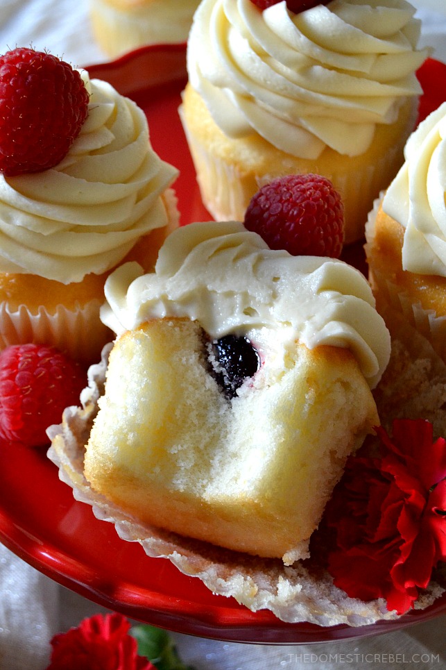 These White Chocolate Raspberry Cupcakes are moist, tender vanilla cupcakes filled with a tart and tangy raspberry jam and topped with a silky mountain of white chocolate buttercream! Sweet, creamy, soft and delicious! 