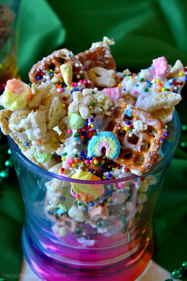 This Lucky Magic Puppy Chow is addictive, easy and feeds a huge crowd! Chock-full of Lucky Charms, pretzels, and mini cereal marshmallows, it's coated in a sweet white chocolate coating and makes a great party food or snack! 