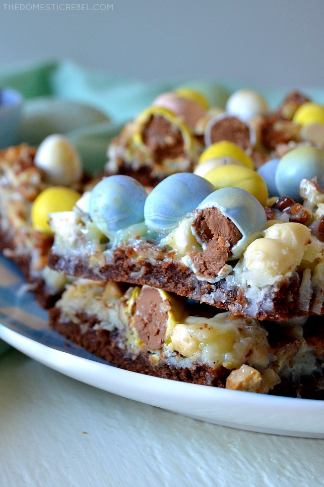 These Cadbury Egg Magic Bars are crunchy, creamy, chewy and gooey with coconut, pecans, white chocolate and Cadbury mini eggs on a fudge brownie crust! Super easy, comes together quickly and they're so perfect for Easter and springtime celebrations!