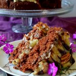 This is the most amazing German Chocolate Cake recipe! Moist, tender chocolate cake surrounded by scratch-made, buttery coconut pecan frosting! Rich and decadent yet simple, this cake needs to make it into your recipe box!