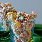 This Lucky Magic Puppy Chow is addictive, easy and feeds a huge crowd! Chock-full of Lucky Charms, pretzels, and mini cereal marshmallows, it's coated in a sweet white chocolate coating and makes a great party food or snack!