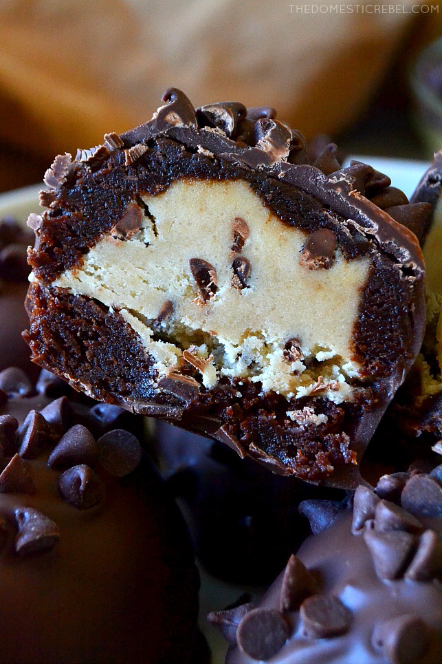 These No-Bake Chocolate Chip Cookie Dough Brownie Bombs are easy, addictive and come together quickly to cure all your cravings! Egg-free chocolate chip cookie dough is surrounded by a baked fudgy brownie and coated in chocolate in these delicious, unique treats! 
