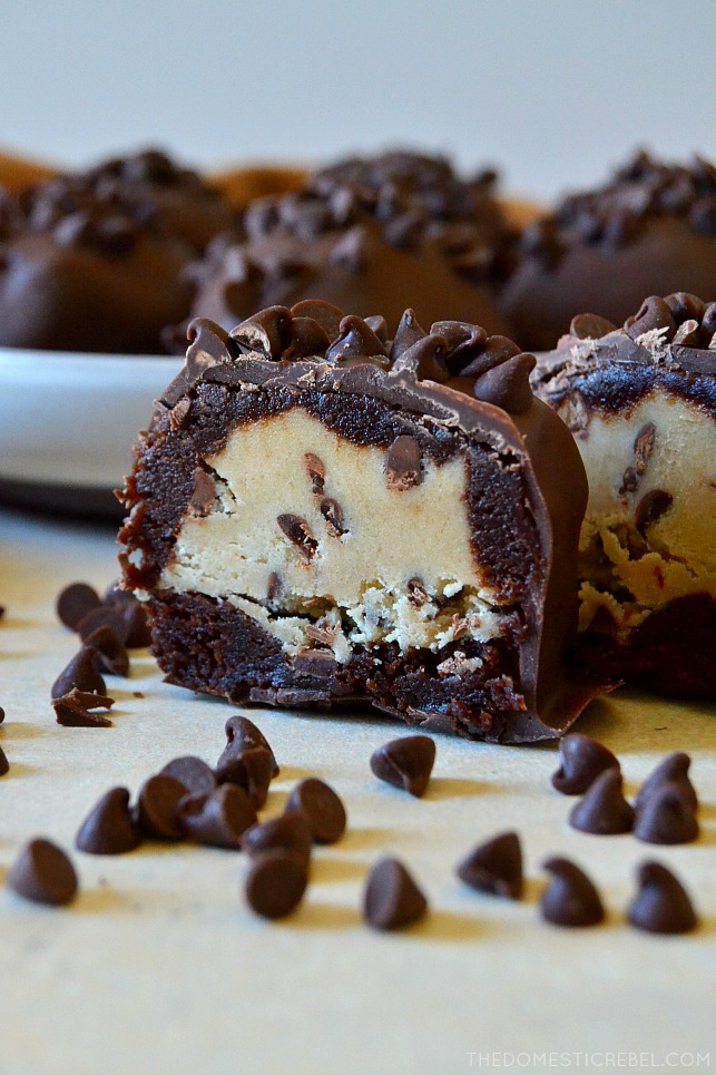 These No-Bake Chocolate Chip Cookie Dough Brownie Bombs are easy, addictive and come together quickly to cure all your cravings! Egg-free chocolate chip cookie dough is surrounded by a baked fudgy brownie and coated in chocolate in these delicious, unique treats! 