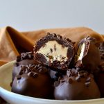 These No-Bake Chocolate Chip Cookie Dough Brownie Bombs are easy, addictive and come together quickly to cure all your cravings! Egg-free chocolate chip cookie dough is surrounded by a baked fudgy brownie and coated in chocolate in these delicious, unique treats!