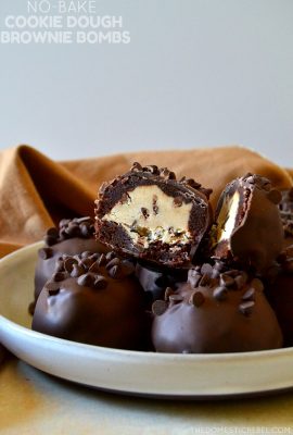 These No-Bake Chocolate Chip Cookie Dough Brownie Bombs are easy, addictive and come together quickly to cure all your cravings! Egg-free chocolate chip cookie dough is surrounded by a baked fudgy brownie and coated in chocolate in these delicious, unique treats!