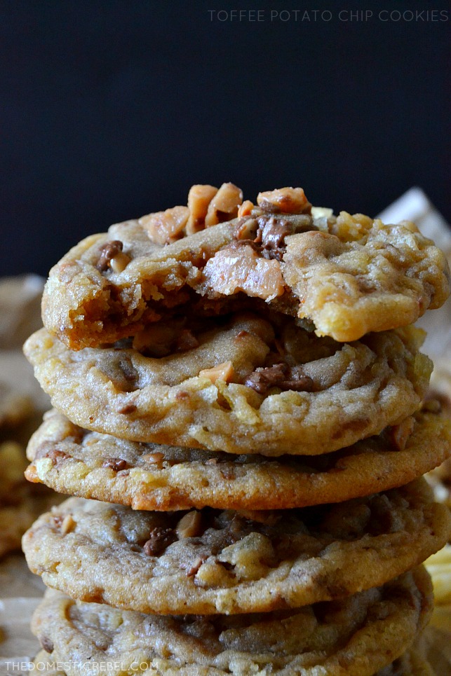 toffee chip cookies stacked high on dark background