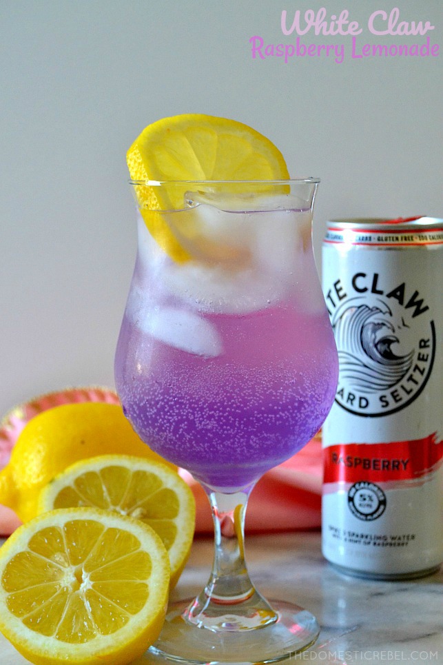 white claw raspberry lemonade in tall glass with lemon wedges