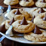 These all-butter Peanut Butter Blossom Cookies are the BEST recipe I've tried! Soft, chewy, perfectly peanut buttery with crisp outer edges and an addictive kiss of chocolate in the center! No chilling required and no shortening in sight for buttery, tender cookies!