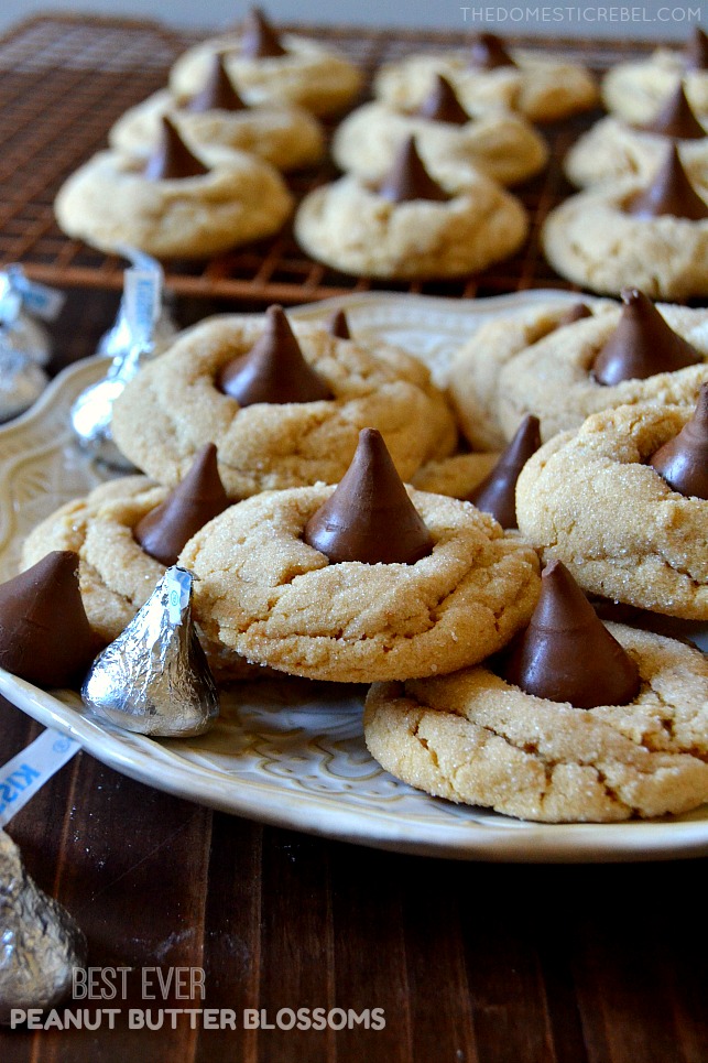 peanut butter blossom cookies on white plate with hershey kiss candies