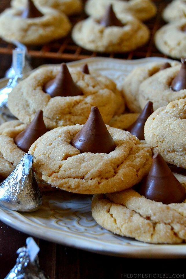 closeup of stacked peanut butter blossoms on white plate