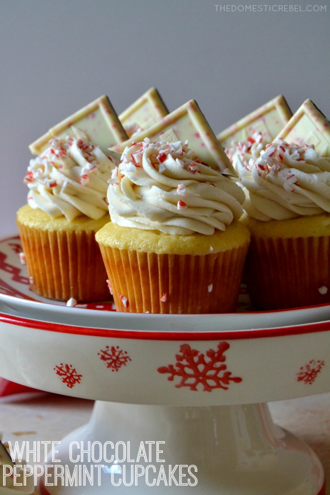 white chocolate peppermint cupcakes arranged on red and white cake stand
