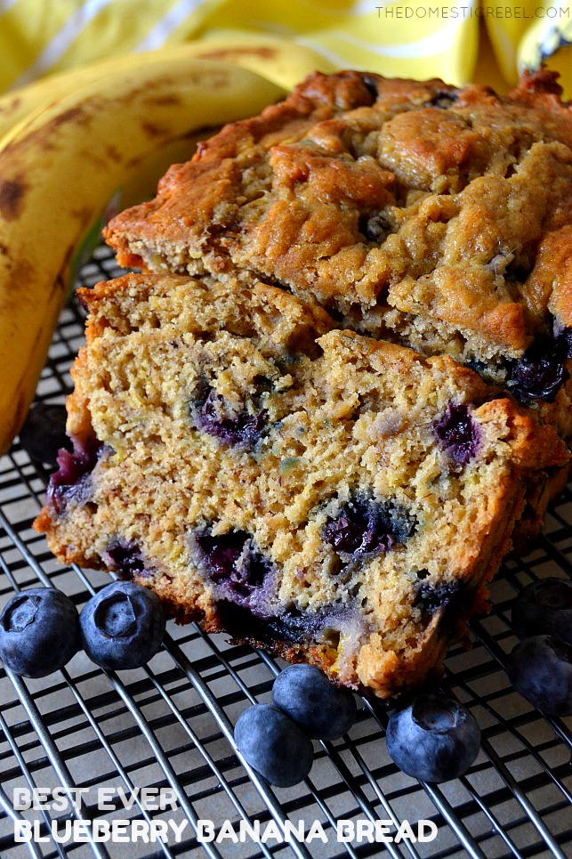 blueberry banana bread on wire rack with bananas and blueberries