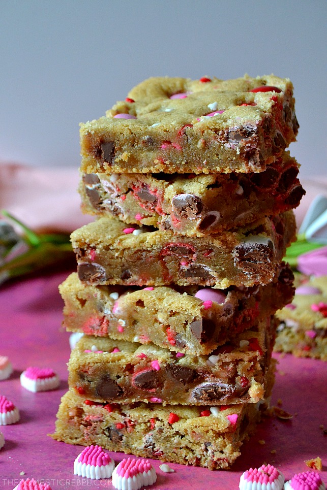 tall stack of valentine m&m cookie bars on pink background